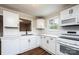 Updated kitchen with white cabinets, stainless appliances, and hardwood flooring at 210 W 15Th St, Newton, NC 28658