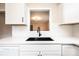 Close-up of the kitchen sink and cabinets with hardwood floors at 210 W 15Th St, Newton, NC 28658