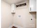 Dedicated laundry area with cabinet storage, shelf and modern fixtures at 210 W 15Th St, Newton, NC 28658