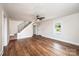 Living room featuring hardwood floors, a staircase, fresh paint, and windows at 210 W 15Th St, Newton, NC 28658