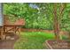 Well-maintained backyard with a wooden deck, green lawn, and privacy fencing, perfect for outdoor activities at 2100 Sablewood Dr, Charlotte, NC 28205