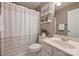 Functional bathroom with a shower and tub combination, a single sink vanity, and decorative shelving at 2100 Sablewood Dr, Charlotte, NC 28205