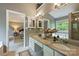 Dual sink bathroom with a separate tub, decorative lighting, and spacious countertops at 2100 Sablewood Dr, Charlotte, NC 28205