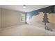 Bedroom featuring a wall mural and a window overlooking the backyard at 2100 Sablewood Dr, Charlotte, NC 28205