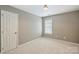 Cozy bedroom with neutral walls, carpeted floor, and a bright window at 2100 Sablewood Dr, Charlotte, NC 28205
