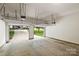 Open garage with overhead storage racks and an automatic door opener for convenience at 2100 Sablewood Dr, Charlotte, NC 28205