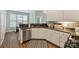 Charming kitchen features granite countertops, stainless steel appliances, and a stylish black and white rug at 2100 Sablewood Dr, Charlotte, NC 28205