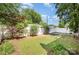 Large, grass-filled backyard with a white privacy fence and mature trees at 2109 Brewton Dr, Charlotte, NC 28206