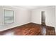 Spacious bedroom features hardwood floors and a window with natural light at 2109 Brewton Dr, Charlotte, NC 28206