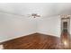 Spacious bedroom with hardwood floors, neutral paint, a ceiling fan, and ample natural light at 2109 Brewton Dr, Charlotte, NC 28206