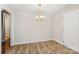 Bright dining room featuring hardwood floors, neutral paint, and a classic chandelier at 2109 Brewton Dr, Charlotte, NC 28206