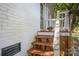 Back entrance with wooden steps and white railings at 2109 Brewton Dr, Charlotte, NC 28206