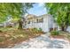 Charming white brick home with a cozy front porch, landscaped yard, and inviting curb appeal at 2109 Brewton Dr, Charlotte, NC 28206