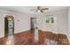 Bright living room featuring hardwood floors, a ceiling fan, neutral paint, and a window with natural light at 2109 Brewton Dr, Charlotte, NC 28206