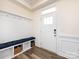 Welcoming entryway with storage bench, coat hooks, and stylish wood-look flooring at 2141 Bexar Trl, Matthews, NC 28105