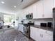Well-equipped kitchen showcases granite counters, stainless steel appliances, and sleek white cabinetry at 2141 Bexar Trl, Matthews, NC 28105