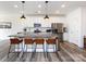 Spacious kitchen with white cabinets, granite counters, island with bar seating, and stainless steel appliances at 2141 Bexar Trl, Matthews, NC 28105