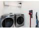 Laundry area with front-loading washer and dryer and convenient storage shelves at 2141 Bexar Trl, Matthews, NC 28105
