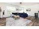 Bright living room featuring a large navy blue sectional sofa and wood-look flooring at 2141 Bexar Trl, Matthews, NC 28105