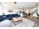 Open-concept living area flows into a modern kitchen with bar seating and staircase at 2141 Bexar Trl, Matthews, NC 28105