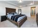 Well-lit main bedroom featuring a tray ceiling, king bed, and large mirror at 2141 Bexar Trl, Matthews, NC 28105