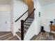 Beautiful staircase with dark wood railings and modern wood-look flooring at 2141 Bexar Trl, Matthews, NC 28105
