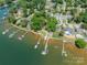 Stunning aerial view showcasing waterfront homes with private docks, lush greenery, and serene lake access at 21614 Colina Dr, Cornelius, NC 28031
