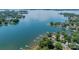 Expansive aerial view of waterfront homes with boat docks on a sunny day surrounded by lush green trees at 21614 Colina Dr, Cornelius, NC 28031