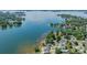 Expansive aerial view of waterfront homes with boat docks on a sunny day surrounded by lush green trees at 21614 Colina Dr, Cornelius, NC 28031