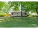 Spacious backyard with a wooden deck and lush green lawn, perfect for outdoor enjoyment at 21614 Colina Dr, Cornelius, NC 28031