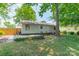 Spacious backyard with a wooden deck and lush green lawn, perfect for outdoor enjoyment at 21614 Colina Dr, Cornelius, NC 28031
