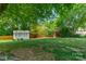 Lush backyard featuring a storage shed, privacy fence, and mature trees at 21614 Colina Dr, Cornelius, NC 28031