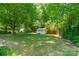 Expansive backyard featuring a storage shed, lush greenery, and a privacy fence at 21614 Colina Dr, Cornelius, NC 28031