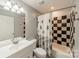 Bathroom with black and white tiled shower and white vanity at 21614 Colina Dr, Cornelius, NC 28031