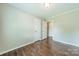Bedroom with wood floors and a door leading to a hallway at 21614 Colina Dr, Cornelius, NC 28031