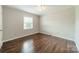 A sunlit bedroom featuring hardwood floors and a ceiling fan at 21614 Colina Dr, Cornelius, NC 28031