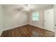 Cozy bedroom featuring hardwood floors, natural light, and a ceiling fan at 21614 Colina Dr, Cornelius, NC 28031