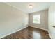 Neutral bedroom offering wood floors, window with natural light, and ample space at 21614 Colina Dr, Cornelius, NC 28031