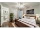 Comfortable bedroom with hardwood floors, a large plant, and an ensuite bathroom view at 21614 Colina Dr, Cornelius, NC 28031