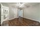 Bedroom featuring wood floors, ceiling fan, and an ensuite bathroom at 21614 Colina Dr, Cornelius, NC 28031