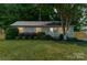 Charming single-story home with manicured lawn and mature trees at 21614 Colina Dr, Cornelius, NC 28031
