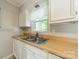 Kitchen sink beneath a window with white cabinetry and light countertops at 21614 Colina Dr, Cornelius, NC 28031