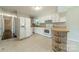 Kitchen featuring white appliances, white cabinets, and durable tile floors at 21614 Colina Dr, Cornelius, NC 28031