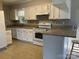Cozy kitchen featuring white cabinets, granite countertops, and appliances at 21614 Colina Dr, Cornelius, NC 28031