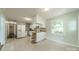 Bright kitchen features white cabinetry, a breakfast bar, and durable floors at 21614 Colina Dr, Cornelius, NC 28031