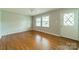 Bright living room with hardwood floors, a ceiling fan, and natural lighting at 21614 Colina Dr, Cornelius, NC 28031