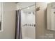 Bright shower with tiled walls and blue-and-beige accent tiles at 21614 Colina Dr, Cornelius, NC 28031