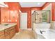 Elegant bathroom featuring a double vanity, soaking tub, a glass-enclosed shower, and decorative wallpaper at 2346 Donnington Nw Ln, Concord, NC 28027