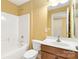 A bathroom with vanity sink and tub/shower combo with tile surround at 2346 Donnington Nw Ln, Concord, NC 28027