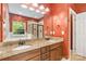 Bathroom featuring double vanity, granite countertops, soaking tub, and a large mirror for natural light at 2346 Donnington Nw Ln, Concord, NC 28027